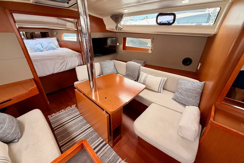 Slide: The Image of Interior of 2017 Beneteau Oceanis 41.1 yacht with cozy seating and elegant wood finish. - 85