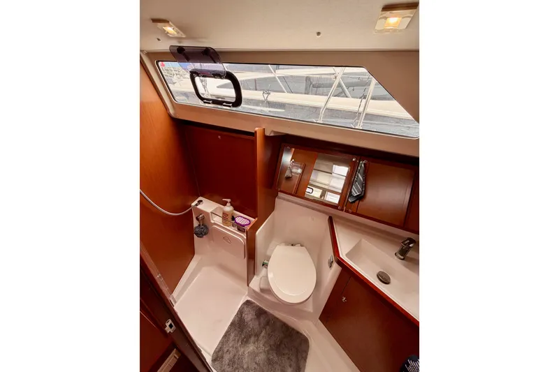 Slide: The Image of Interior of 2017 Beneteau Oceanis 41.1 yacht bathroom with modern fixtures and wood accents. - 75