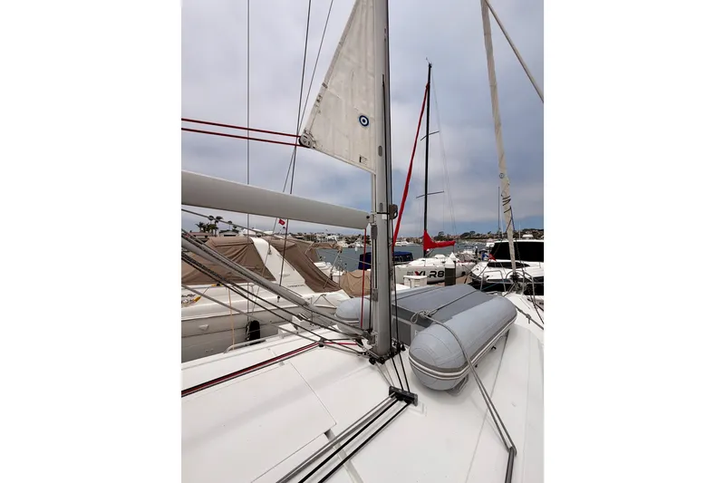 Slide: The Image of 2017 Beneteau Oceanis 41.1 sailboat deck with rigging and inflatable dinghy in marina. - 16