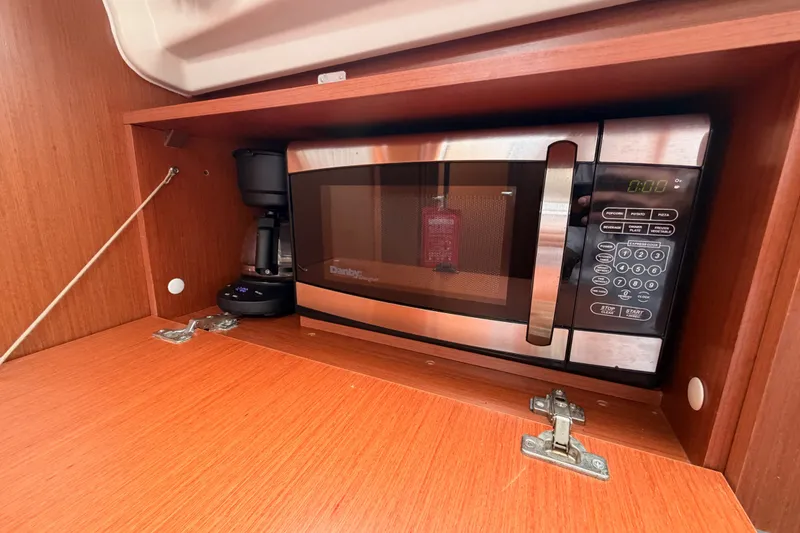 Slide: The Image of Microwave and coffee maker in 2017 Beneteau Oceanis 41.1 yacht's wooden cabinet. - 66