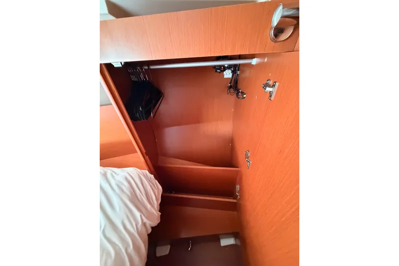 Slide: The Image of Interior view of a 2017 Beneteau Oceanis 41.1 yacht's wooden storage cabinet. - 101