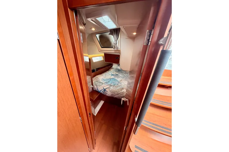 Slide: The Image of Cozy cabin interior of 2017 Beneteau Oceanis 41.1 sailboat with wooden finish and bedding. - 77