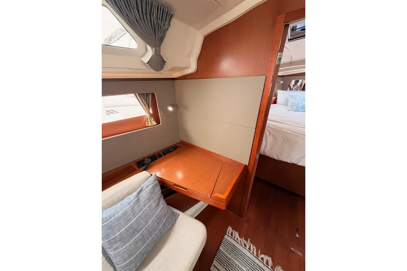 Slide: The Image of Interior of 2017 Beneteau Oceanis 41.1 yacht with wooden desk and cozy seating. - 95