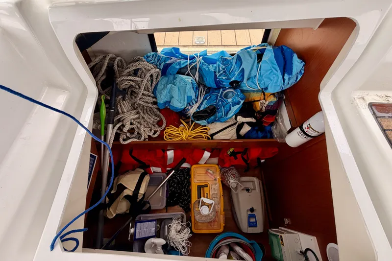Slide: The Image of Storage compartment of a 2017 Beneteau Oceanis 41.1 sailboat, filled with ropes and gear. - 52