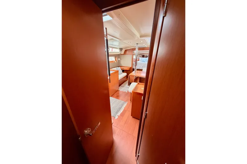 Slide: The Image of Interior view of 2017 Beneteau Oceanis 41.1 yacht, featuring elegant wood finishes and cozy cabin. - 82