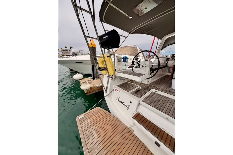 Slide: The Image of 2017 Beneteau Oceanis 41.1 yacht docked, featuring a spacious cockpit and steering wheel. - 34