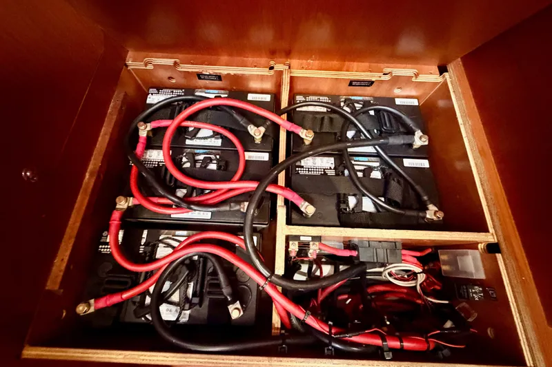 Slide: The Image of Battery compartment of a 2017 Beneteau Oceanis 41.1 sailboat with red and black cables. - 70