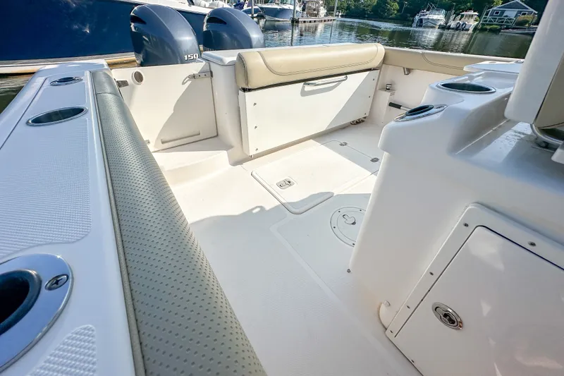Slide: The Image of 2018 Pursuit C 260 Center Console boat interior with seating and storage compartments. - 44