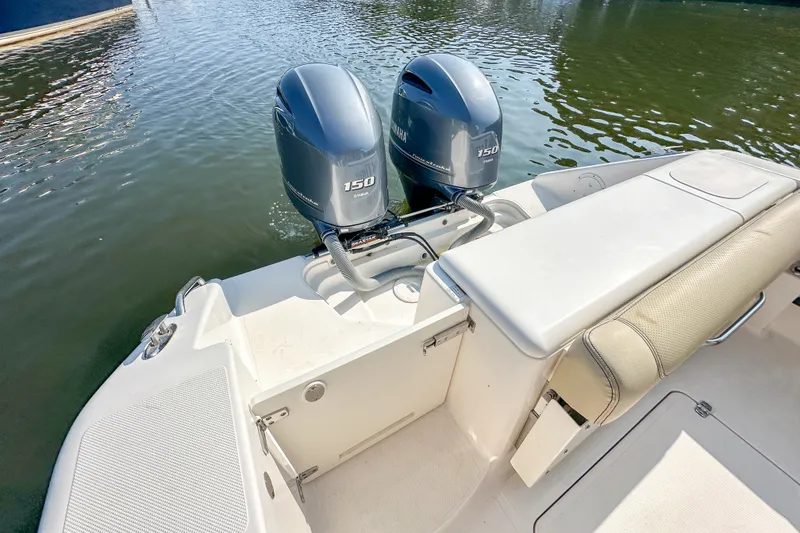 Slide: The Image of 2018 Pursuit C 260 Center Console boat with dual Yamaha 150 engines on water. - 49