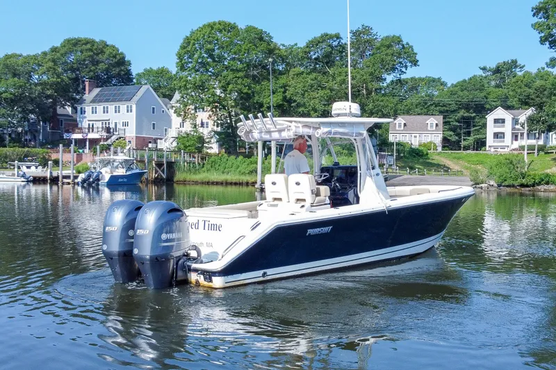 Slide: The Image of 2018 Pursuit C 260 Center Console boat on calm water near residential area. - 11