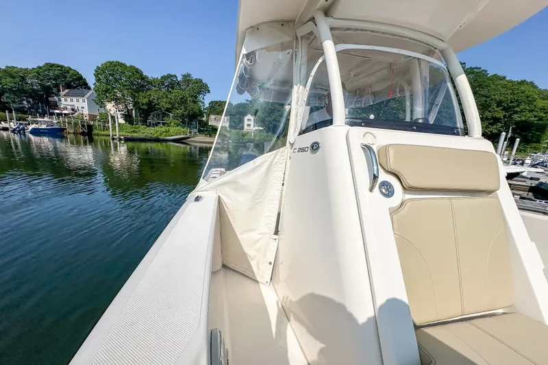 Slide: The Image of 2018 Pursuit C 260 Center Console boat docked in a serene marina setting. - 41