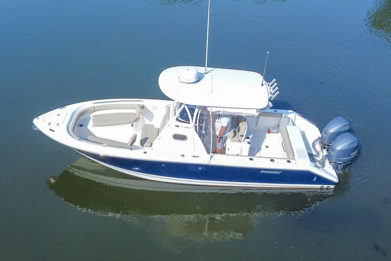 Slide: The Image of 2018 Pursuit C 260 Center Console boat on calm water, featuring dual engines. - 20