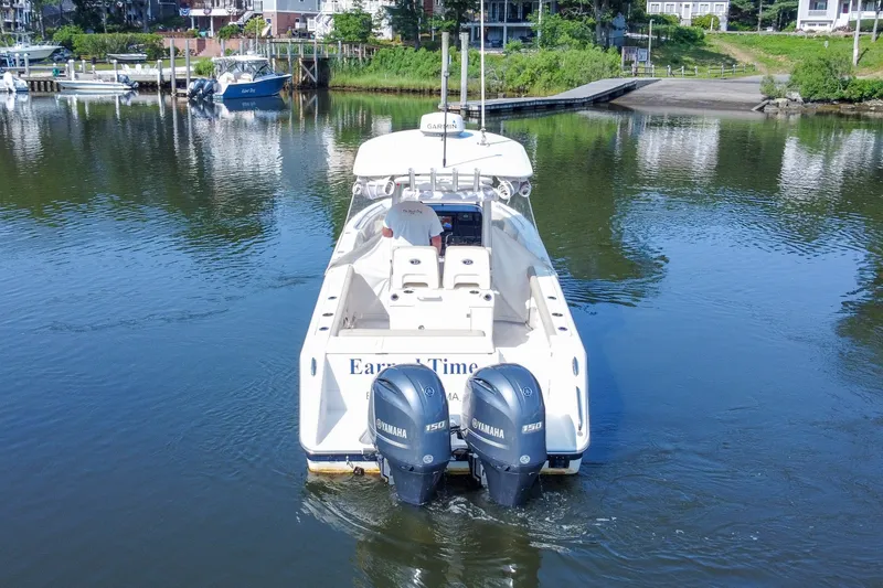 Slide: The Image of 2018 Pursuit C 260 Center Console boat with twin Yamaha engines on a calm river. - 9