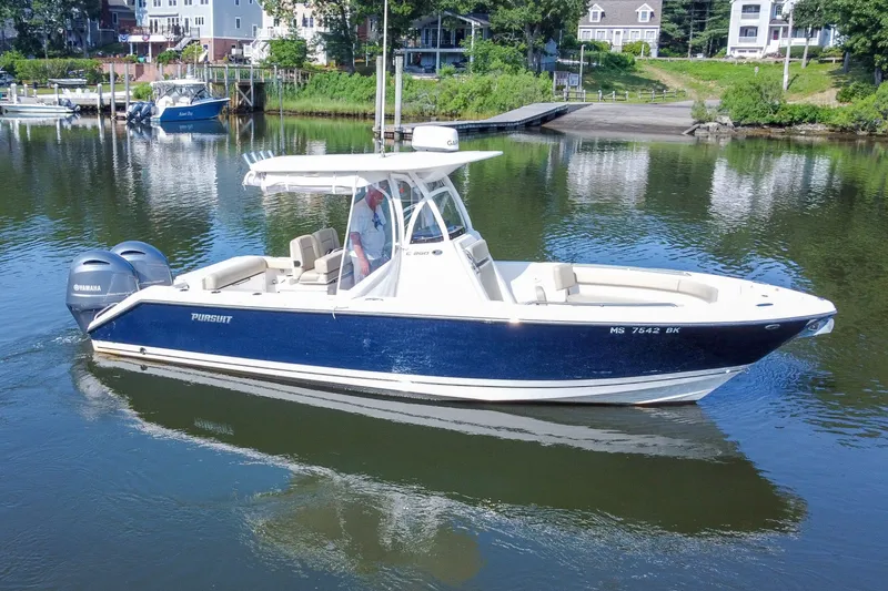Slide: The Image of 2018 Pursuit C 260 Center Console boat on calm water, featuring dual Yamaha engines. - 14