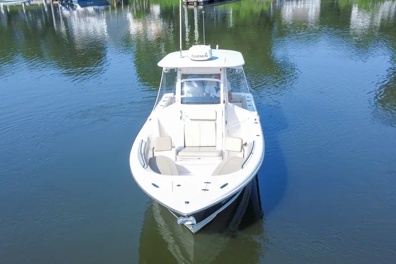 Slide: The Image of 2018 Pursuit C 260 Center Console boat on calm water, aerial view. - 17