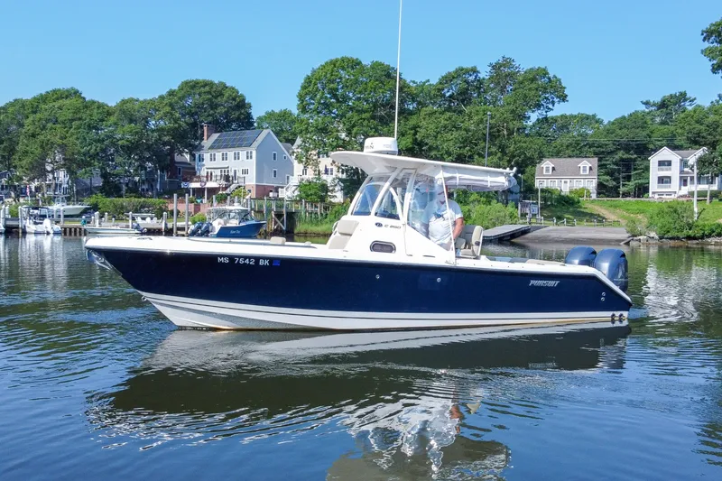 Slide: The Image of 2018 Pursuit C 260 Center Console boat on calm water near residential shoreline. - 4