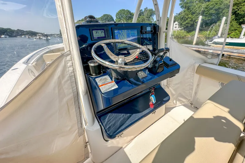 Slide: The Image of 2018 Pursuit C 260 Center Console helm with steering wheel and navigation displays. - 29