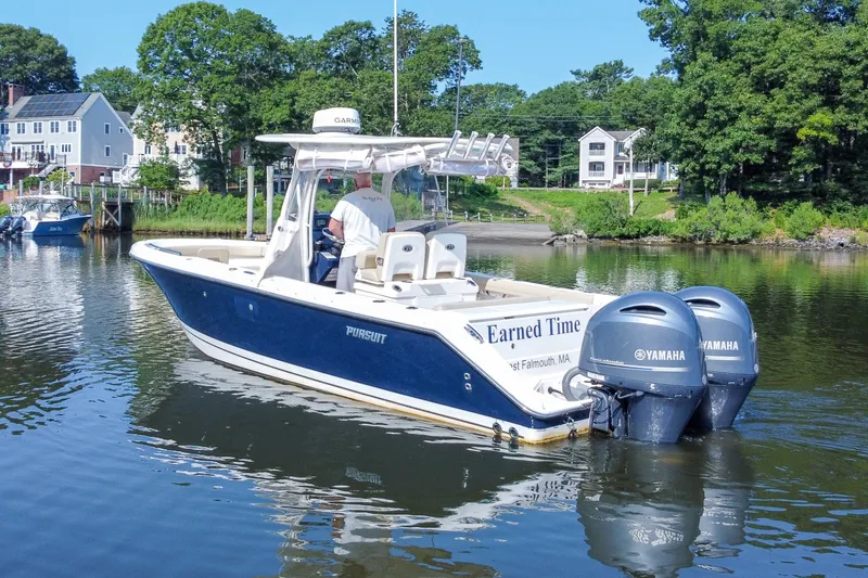 Slide: The Image of 2018 Pursuit C 260 Center Console boat on calm water, featuring twin Yamaha engines. - 8