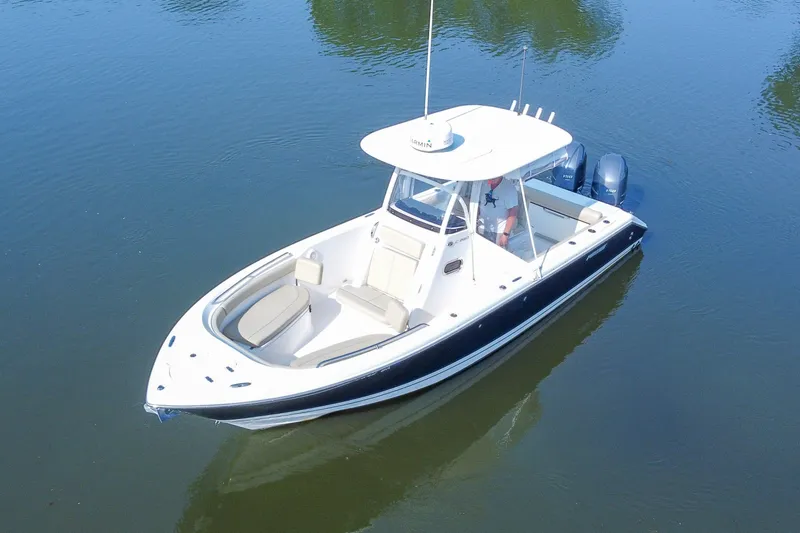 Slide: The Image of 2018 Pursuit C 260 Center Console boat on calm water, aerial view. - 18