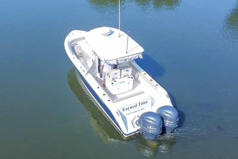 Slide: The Image of 2018 Pursuit C 260 Center Console boat on calm water, featuring twin Yamaha engines. - 22