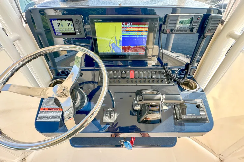Slide: The Image of 2018 Pursuit C 260 Center Console dashboard with navigation and control systems. - 26