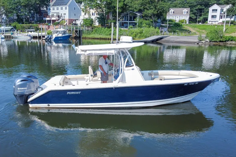 Slide: The Image of 2018 Pursuit C 260 Center Console boat on calm water near residential area. - 13