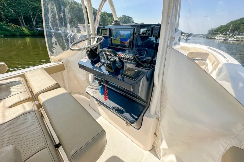 Slide: The Image of 2018 Pursuit C 260 Center Console boat interior with navigation equipment and seating. - 28