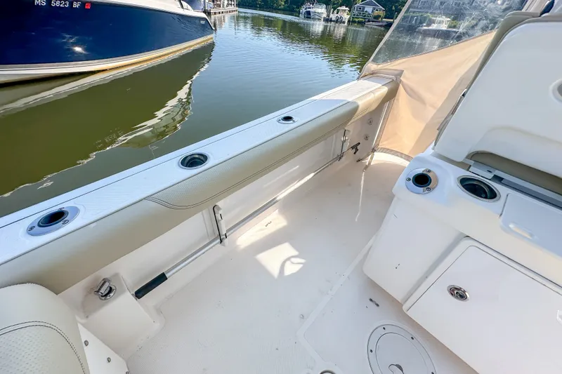 Slide: The Image of 2018 Pursuit C 260 Center Console boat interior with seating and cup holders. - 47