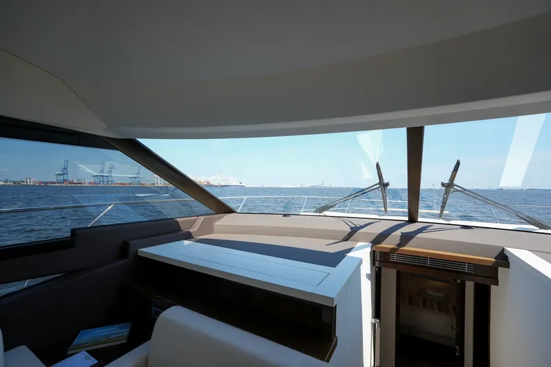 Slide: The Image of Interior view of 2023 Prestige 590 yacht with ocean and port in background. - 66