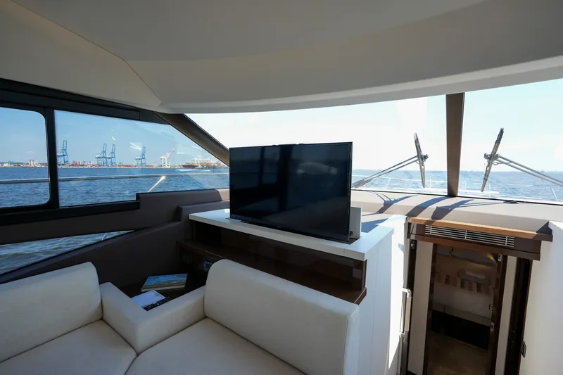 Slide: The Image of Luxurious interior of 2023 Prestige 590 yacht with TV and ocean view. - 67