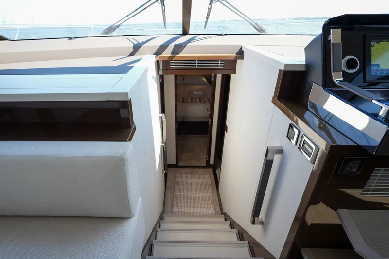 Slide: The Image of Luxurious interior of 2023 Prestige 590 yacht, featuring modern design and advanced navigation system. - 75