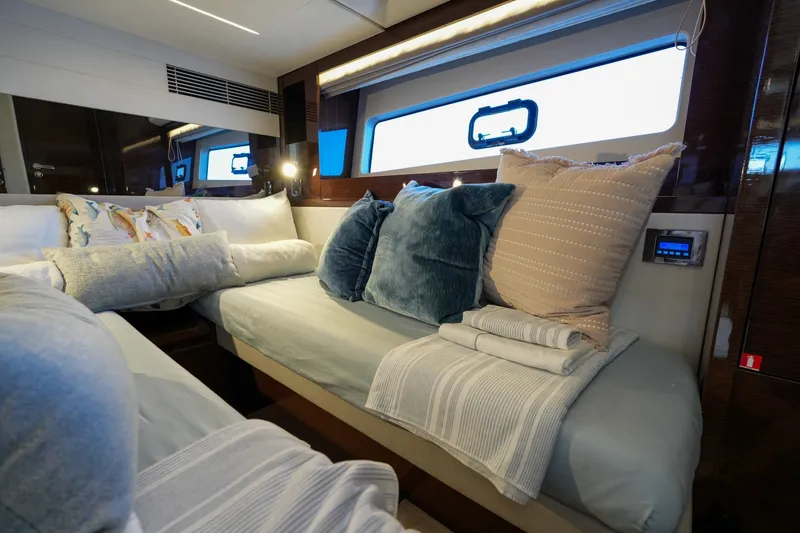 Slide: The Image of Luxurious interior of 2023 Prestige 590 yacht with plush bedding and elegant decor. - 85