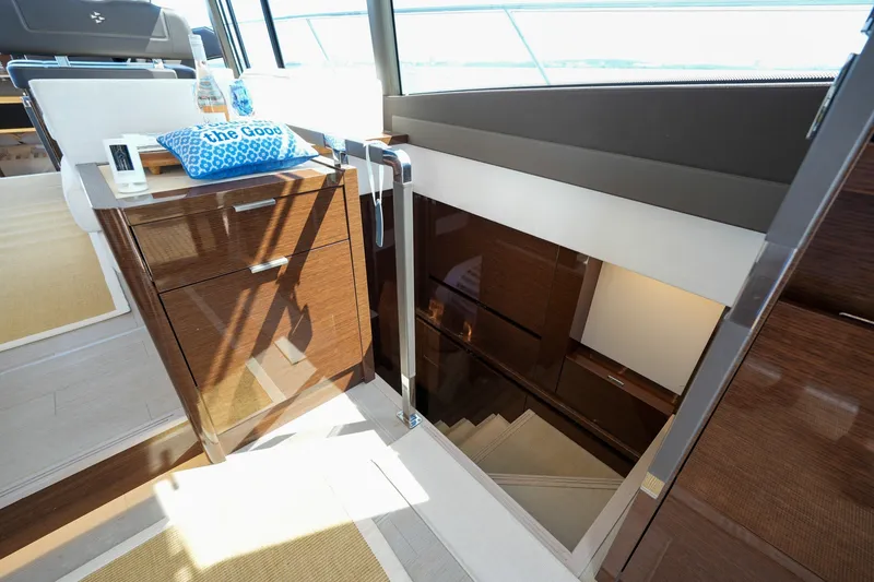 Slide: The Image of Luxurious interior of 2023 Prestige 590 yacht with elegant wooden cabinetry and staircase. - 89