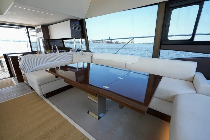 Slide: The Image of Luxurious interior of 2023 Prestige 590 yacht with elegant seating and panoramic windows. - 63