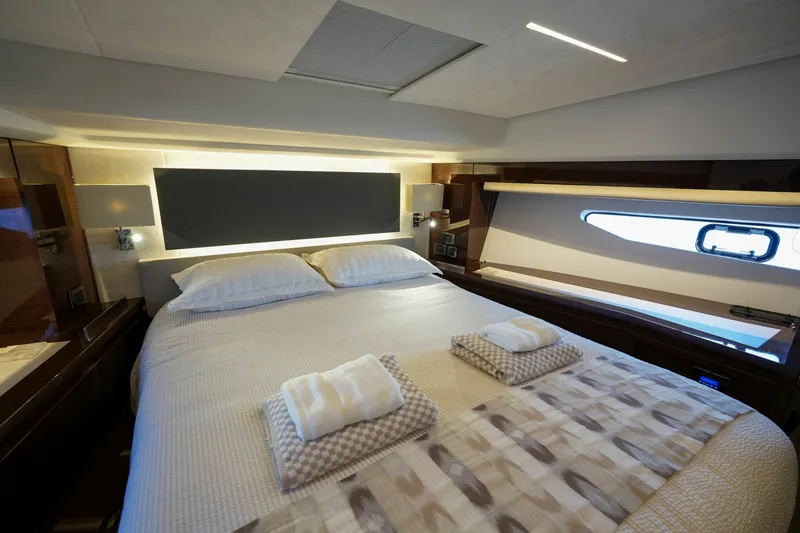Slide: The Image of Luxurious bedroom interior of 2023 Prestige 590 yacht with elegant bedding and modern lighting. - 79