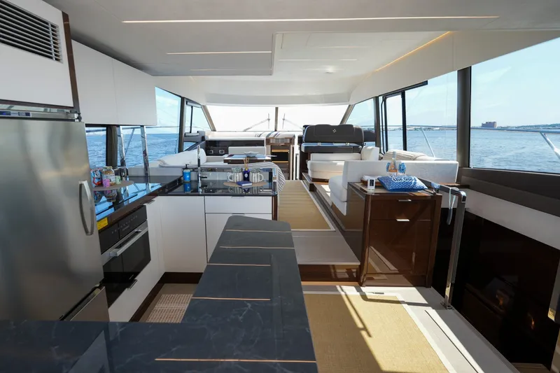 Slide: The Image of Luxurious interior of 2023 Prestige 590 yacht with modern kitchen and seating area. - 51