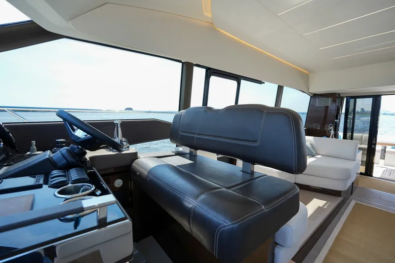 Slide: The Image of Luxurious interior of 2023 Prestige 590 yacht with modern helm and seating. - 68