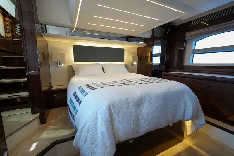Slide: The Image of Luxurious bedroom interior of 2023 Prestige 590 yacht with modern design and ambient lighting. - 2