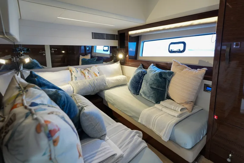 Slide: The Image of Luxurious interior of 2023 Prestige 590 yacht with plush bedding and elegant decor. - 83