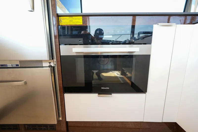 Slide: The Image of Modern kitchen appliance setup on a 2023 Prestige 590 yacht. - 57