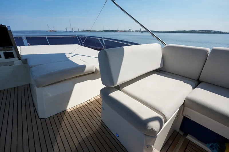 Slide: The Image of Luxurious seating on 2023 Prestige 590 yacht with ocean view and wooden deck. - 32