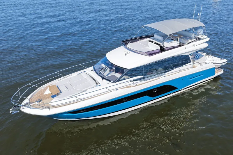 Slide: The Image of Luxury 2023 Prestige 590 yacht cruising on calm waters, featuring sleek design and spacious deck. - 5