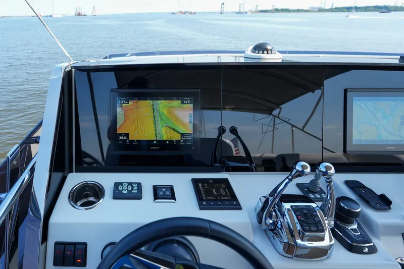 Slide: The Image of Helm of 2023 Prestige 590 yacht with advanced navigation systems and controls. - 39