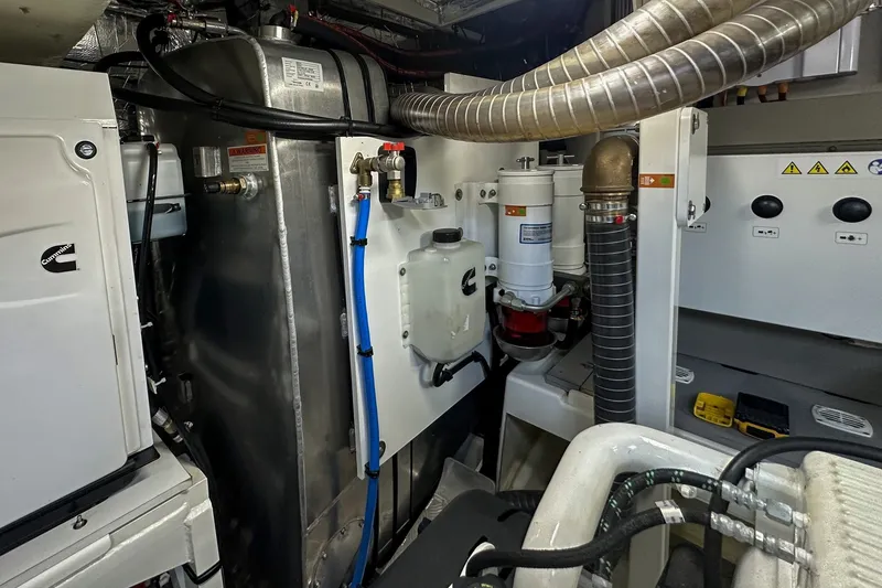 Slide: The Image of Engine room of 2023 Prestige 590 yacht with mechanical components and piping. - 105