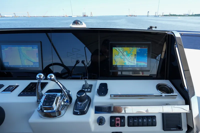 Slide: The Image of Control panel of 2023 Prestige 590 yacht with navigation screens and controls. - 40