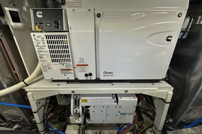 Slide: The Image of Engine room of 2023 Prestige 590 yacht featuring Onan Marine QD generator. - 106