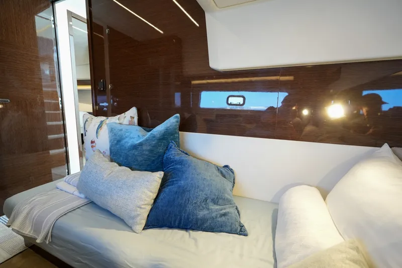 Slide: The Image of Luxurious interior of 2023 Prestige 590 yacht with plush cushions and sleek wood paneling. - 87