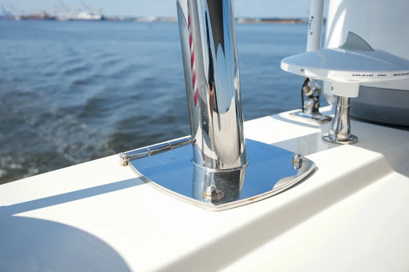 Slide: The Image of Close-up of 2023 Prestige 590 yacht's polished chrome fittings on deck, with ocean backdrop. - 44
