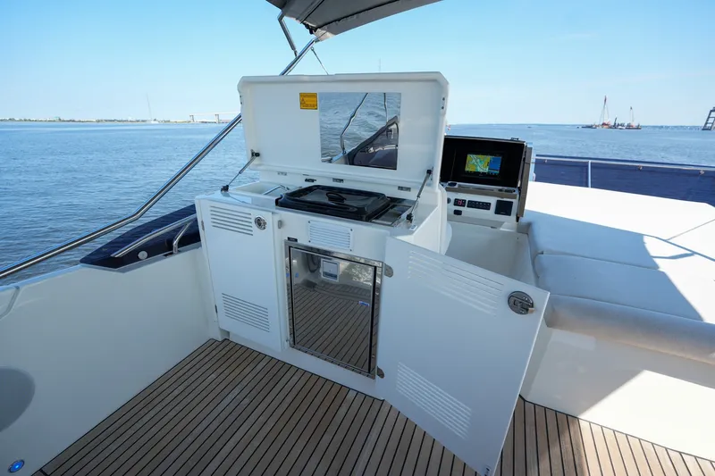 Slide: The Image of Luxury yacht Prestige 590, 2023 model, featuring an outdoor kitchen with ocean view. - 42