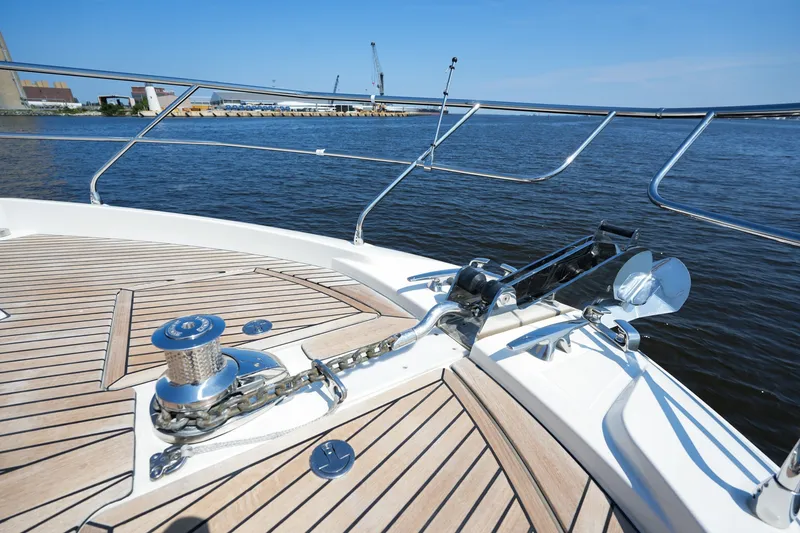 Slide: The Image of Prestige 590 yacht deck with anchor system, 2023 model, on calm water. - 50